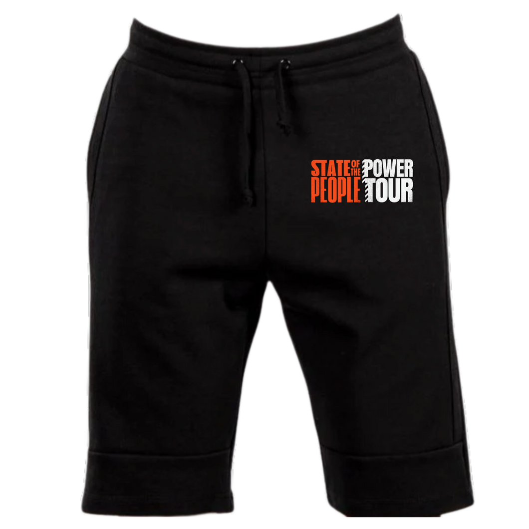 Black jogger-style shorts featuring an elastic waistband with drawstrings and the 